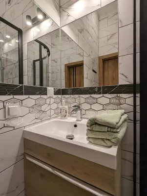 a bathroom with a sink and a mirror at Apartment A2 in Downtown of Krakow in Kraków