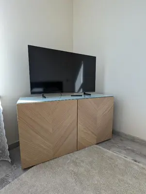 a flat screen tv sitting on top of a wooden cabinet at Apartment A2 in Downtown of Krakow in Kraków