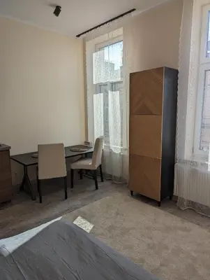 a room with a desk and a table and a cabinet at Apartment A2 in Downtown of Krakow in Kraków