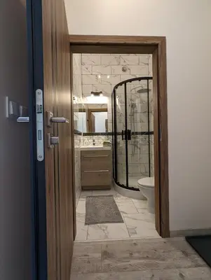 a bathroom with a shower and a toilet and a mirror at Apartment A2 in Downtown of Krakow in Kraków