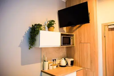a small kitchen with a counter with a microwave and a counter sidx sidx at Hot Jacuzzi in Cracow in Kraków
