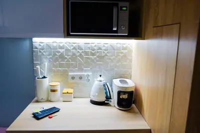 a kitchen counter with a coffee maker and a microwave at Hot Jacuzzi in Cracow in Kraków