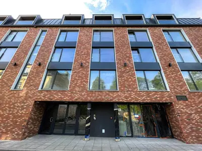 a large brick building with a lot of windows at Hot Jacuzzi in Cracow in Kraków