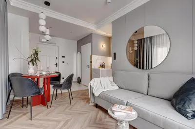 a living room with a couch and a table and a mirror at MameHome Apartments in Kraków