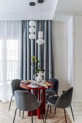 a dining room with a red table and chairs at MameHome Apartments in Kraków
