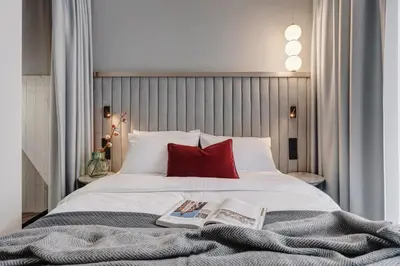 a bedroom with a bed with a book on it at MameHome Apartments in Kraków