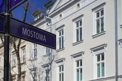 a blue street sign in front of a building at MameHome Apartments in Kraków