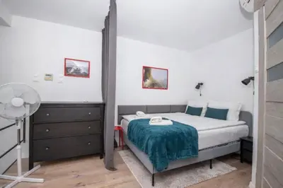 a bedroom with a bed with a blue blanket at InPoint Modern Loft - City Centre Łazarza St 13 Self Check-in in Kraków