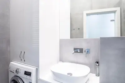 a bathroom with a sink and a washing machine at RentPlanet - Apartament Wieliczka in Wieliczka