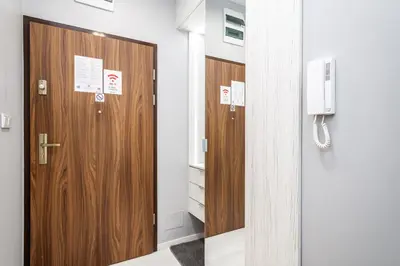 a row of wooden doors in a room at RentPlanet - Apartament Wieliczka in Wieliczka