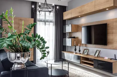 a living room with a black couch and a tv at RentPlanet - Apartament Wieliczka in Wieliczka
