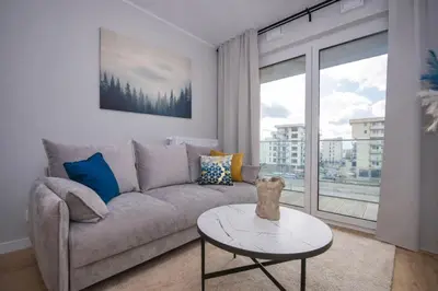 a living room with a couch and a table at InPoint Modern Apartment Lema 17-Tauron Arena & Free Parking Self Check-in in Kraków