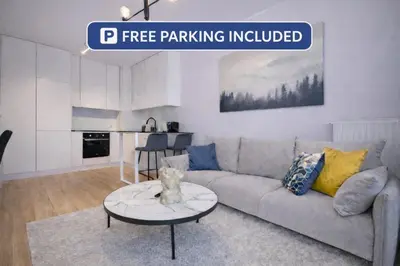 a living room with a couch and a table at InPoint Modern Apartment Lema 17-Tauron Arena & Free Parking Self Check-in in Kraków
