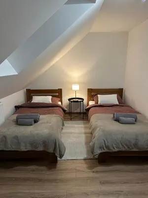 two beds in a room with a attic at Bartosówka Apartament in Rajbrot
