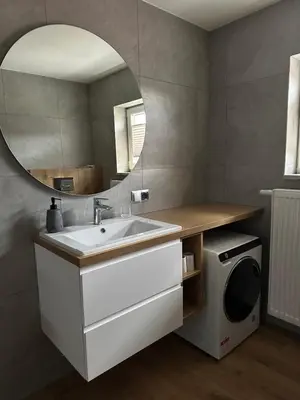 a bathroom with a sink and a mirror at Bartosówka Apartament in Rajbrot