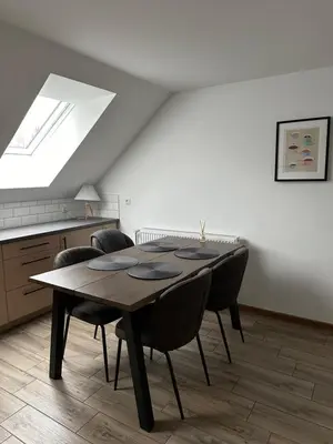 a dining room with a table and some chairs at Bartosówka Apartament in Rajbrot