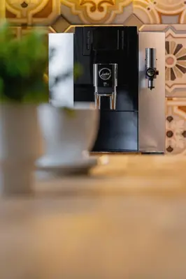 a coffee machine with a cup on a table at Luxury Apartment with Two Bedrooms and Balcony by Renters Prestige in Kraków