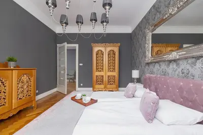 a bedroom with a large bed with a pink headboard at Luxury Apartment with Two Bedrooms and Balcony by Renters Prestige in Kraków