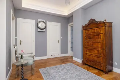 a room with a table and a clock on a wall at Luxury Apartment with Two Bedrooms and Balcony by Renters Prestige in Kraków