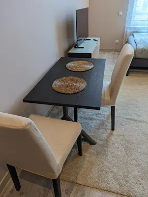 a black dining room table with two chairs and a couch at Apartment A1 in Downtown of Krakow in Kraków