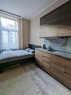 a bedroom with two beds and a sink in it at Apartment A1 in Downtown of Krakow in Kraków