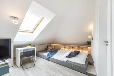 a bedroom with a large bed and a television at MODERN & NEW place next to Wawel Castle & Vistula in Kraków
