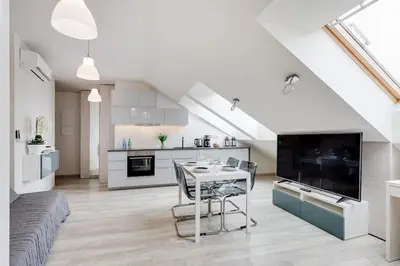 a living room with a table and a kitchen at MODERN & NEW place next to Wawel Castle & Vistula in Kraków