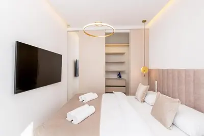a living room with a couch and a tv at Glossy Apart G29 in Kraków