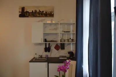 a small kitchen with a counter and a sink at Royal Castle Apartments in Kraków