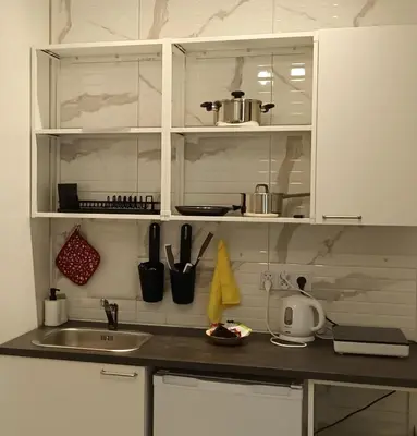 a kitchen with a sink and a counter with utensils at Royal Castle Apartments in Kraków