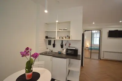 a kitchen with a table and a counter top at Royal Castle Apartments in Kraków