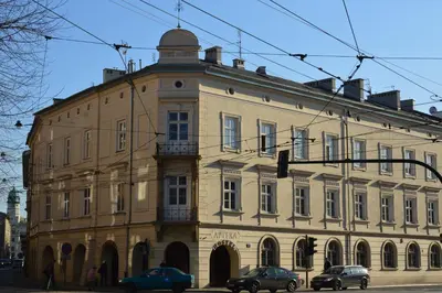 a large building with cars parked in front of it at Royal Castle Apartments in Kraków