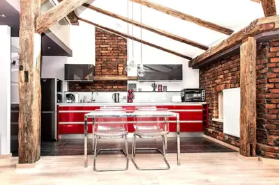 a kitchen with brick walls and a counter with stools at Exclusive loft with Sauna, AC and 3 bathrooms in Kraków