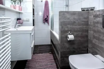 a bathroom with a white toilet and a sink at Exclusive loft with Sauna, AC and 3 bathrooms in Kraków