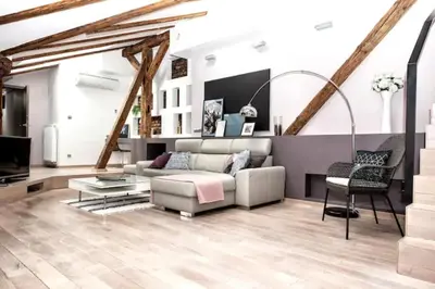 a living room with a couch and a table at Exclusive loft with Sauna, AC and 3 bathrooms in Kraków