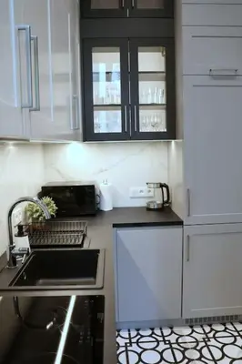 a kitchen with white cabinets and a sink at Exclusive, unique apartment, 2 bathrooms, 105sqm in Kraków