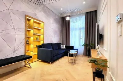 a living room with a blue couch and a table at Exclusive, unique apartment, 2 bathrooms, 105sqm in Kraków
