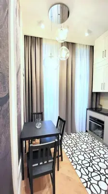 a dining room with a black table and chairs at Exclusive, unique apartment, 2 bathrooms, 105sqm in Kraków
