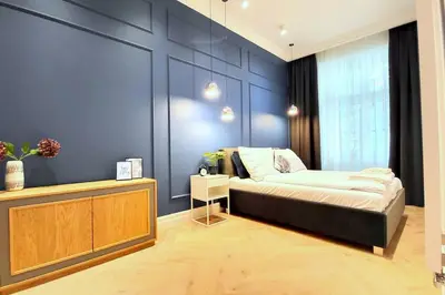 a bedroom with a bed and a blue wall at Exclusive, unique apartment, 2 bathrooms, 105sqm in Kraków