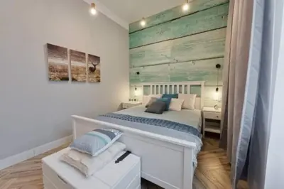a bedroom with a bed and a wooden wall at Wild & Huge comfy apartment 5 min to Main Square in Kraków