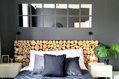 a bedroom with a large wooden headboard and a bed at Wild & Huge comfy apartment 5 min to Main Square in Kraków