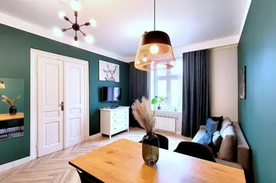 a living room with a table and a couch at Wild & Huge comfy apartment 5 min to Main Square in Kraków