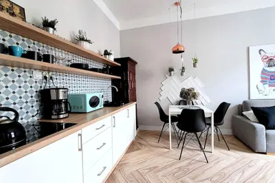 a kitchen with a table and chairs in a room at Wild & Huge comfy apartment 5 min to Main Square in Kraków
