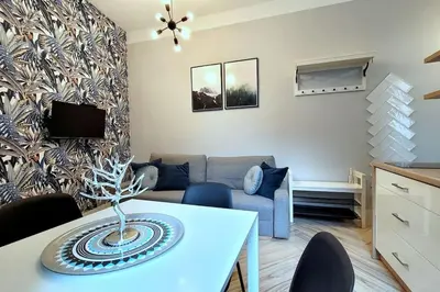 a living room with a couch and a table at Wild & Huge comfy apartment 5 min to Main Square in Kraków