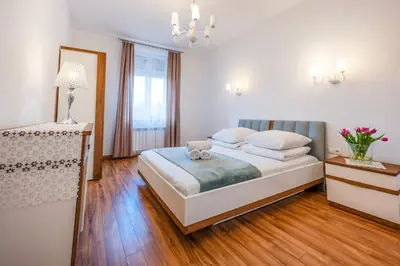 a bedroom with a bed with a teddy bear on it at Florencja Moxy TE&AM Stare Miasto Dworzec 3 min Parking GRATIS in Kraków