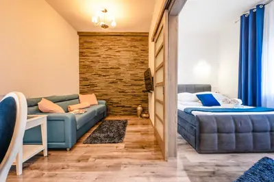 a bedroom with a couch and a bed in a room at Florencja Moxy TE&AM Stare Miasto Dworzec 3 min Parking GRATIS in Kraków