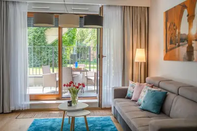 a living room with a couch and a table at Rimini Moxy TE&AM Old Town Free Parking Dworzec 5 min in Kraków