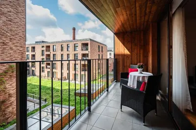 a balcony with a table and a view of a building at Rimini Moxy TE&AM Old Town Free Parking Dworzec 5 min in Kraków
