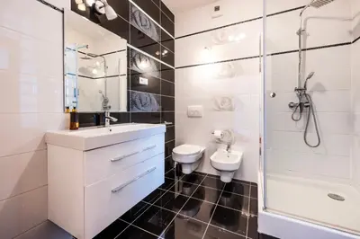 a bathroom with a sink and a toilet and a shower at Rimini Moxy TE&AM Old Town Free Parking Dworzec 5 min in Kraków