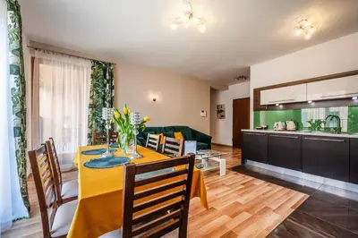 a dining room and kitchen with a table and chairs at Rimini Moxy TE&AM Old Town Free Parking Dworzec 5 min in Kraków